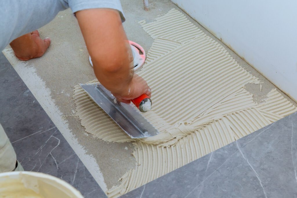 Floor tiles installation. Ceramic tiles and tools for home improvement, renovation